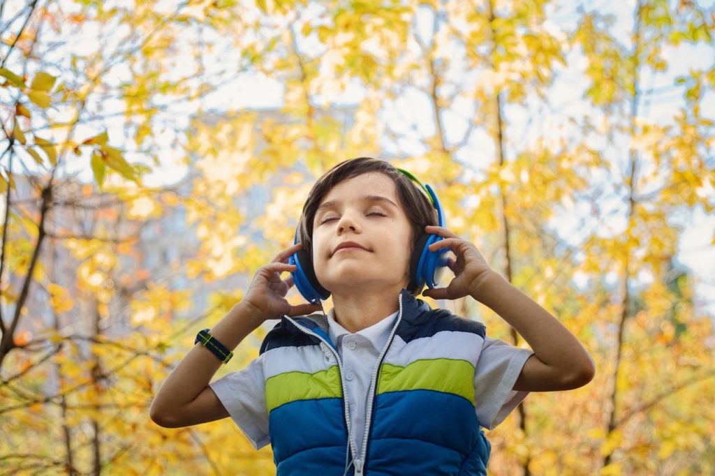 Child listening to headphones